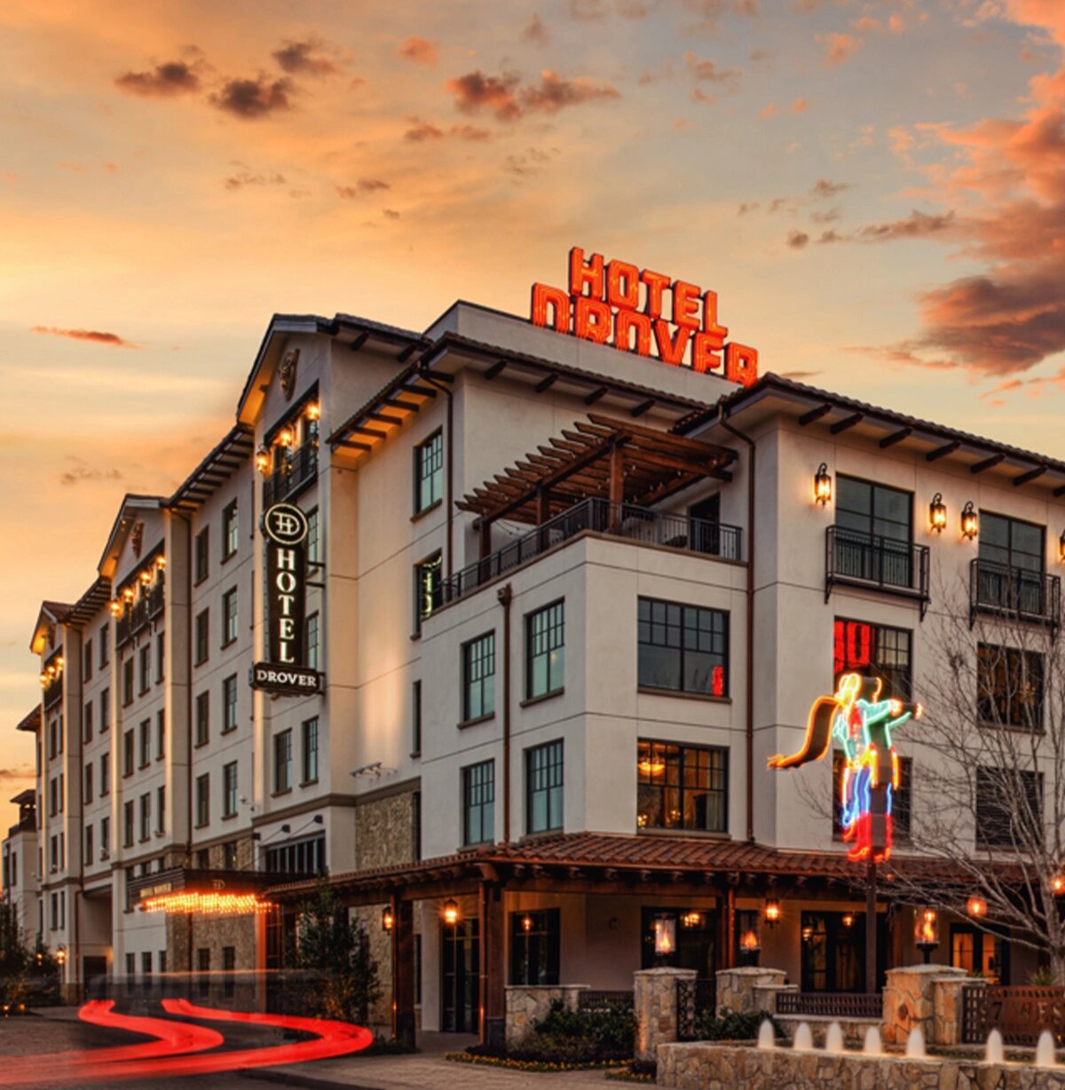 Hotel Drover exterior at sunset with glowing neon sign in the Fort Worth Stockyards
